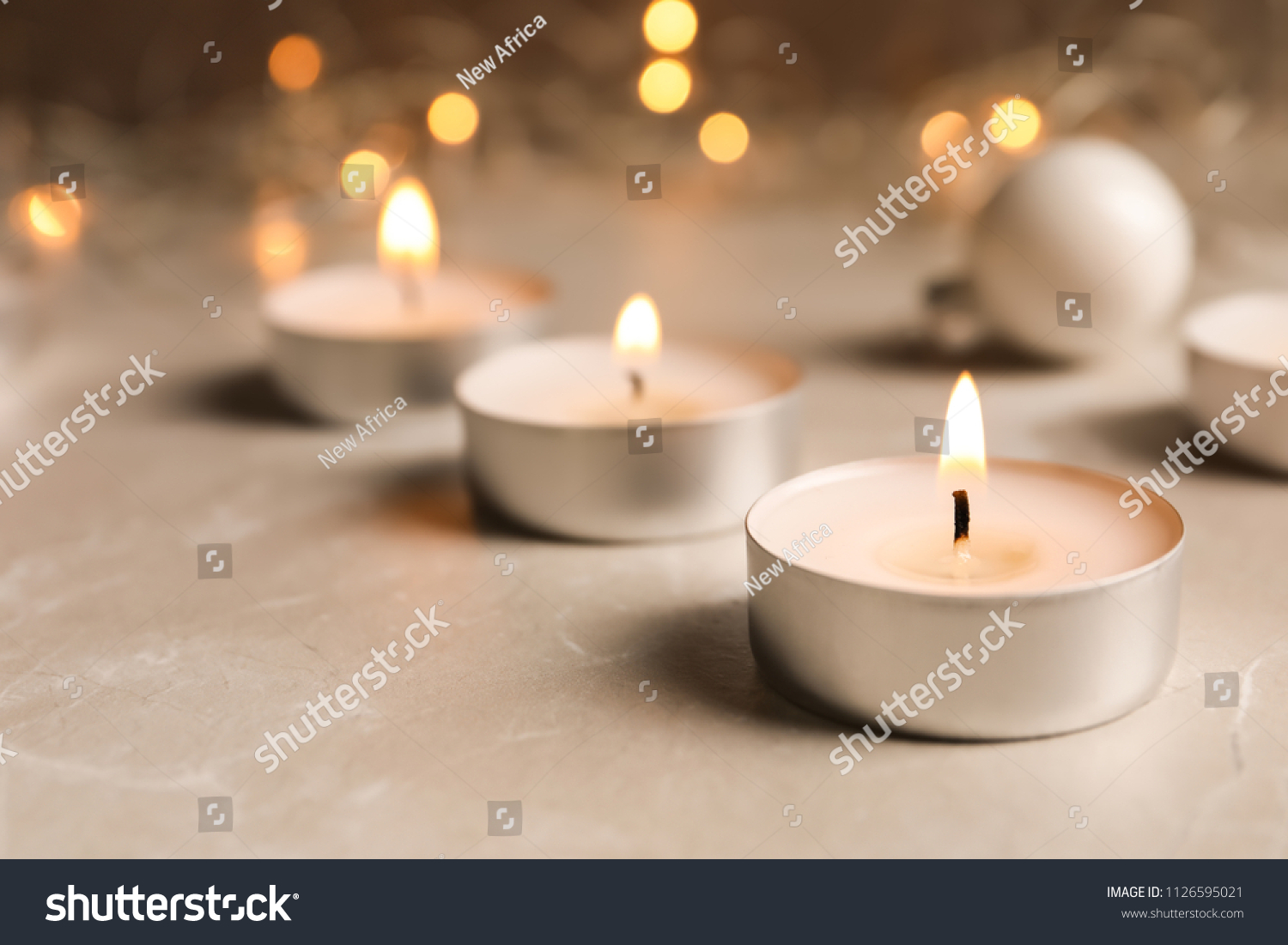 Beautiful burning wax candle on table, closeup #1126595021