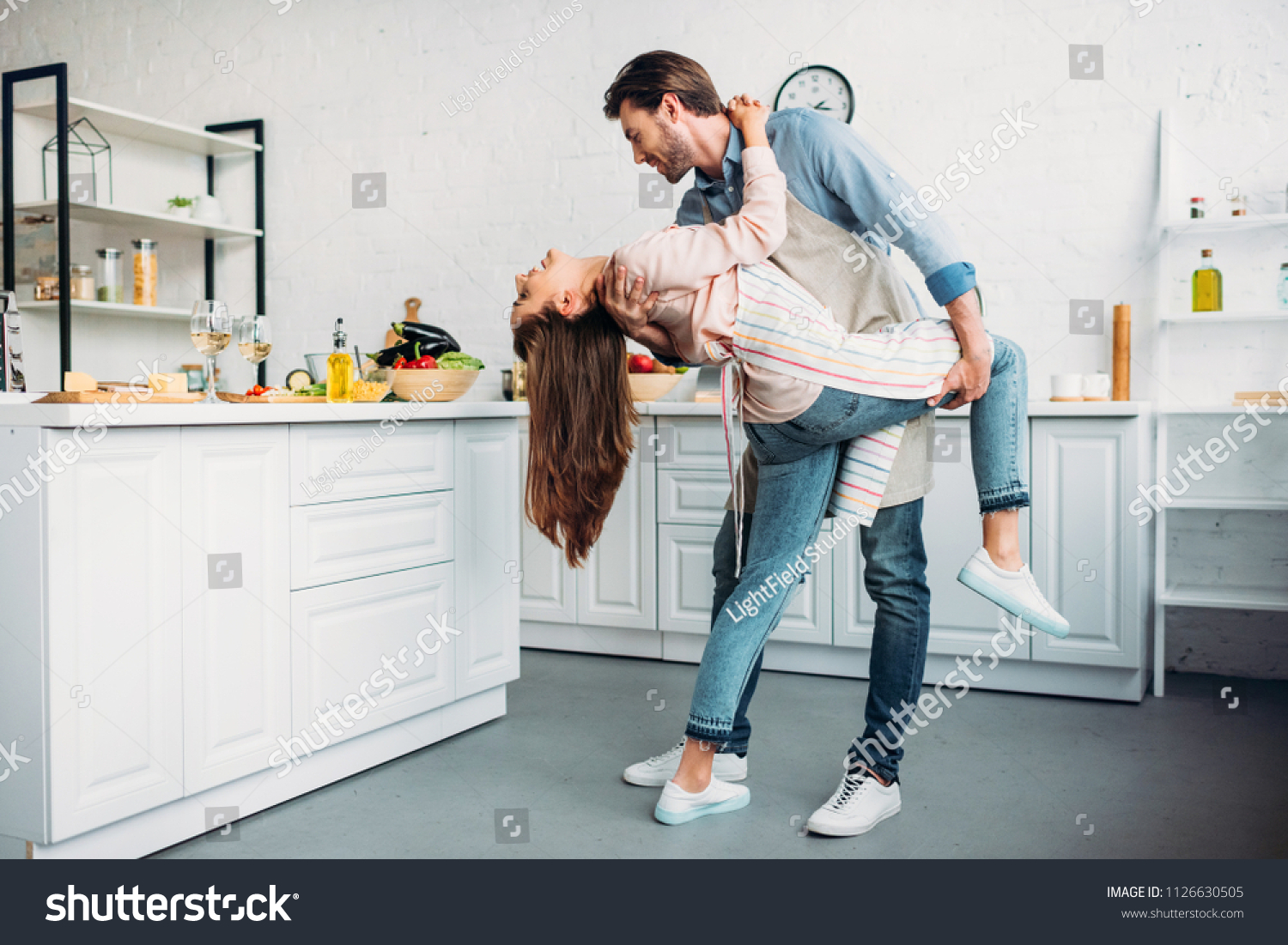 couple dancing tango together in kitchen #1126630505