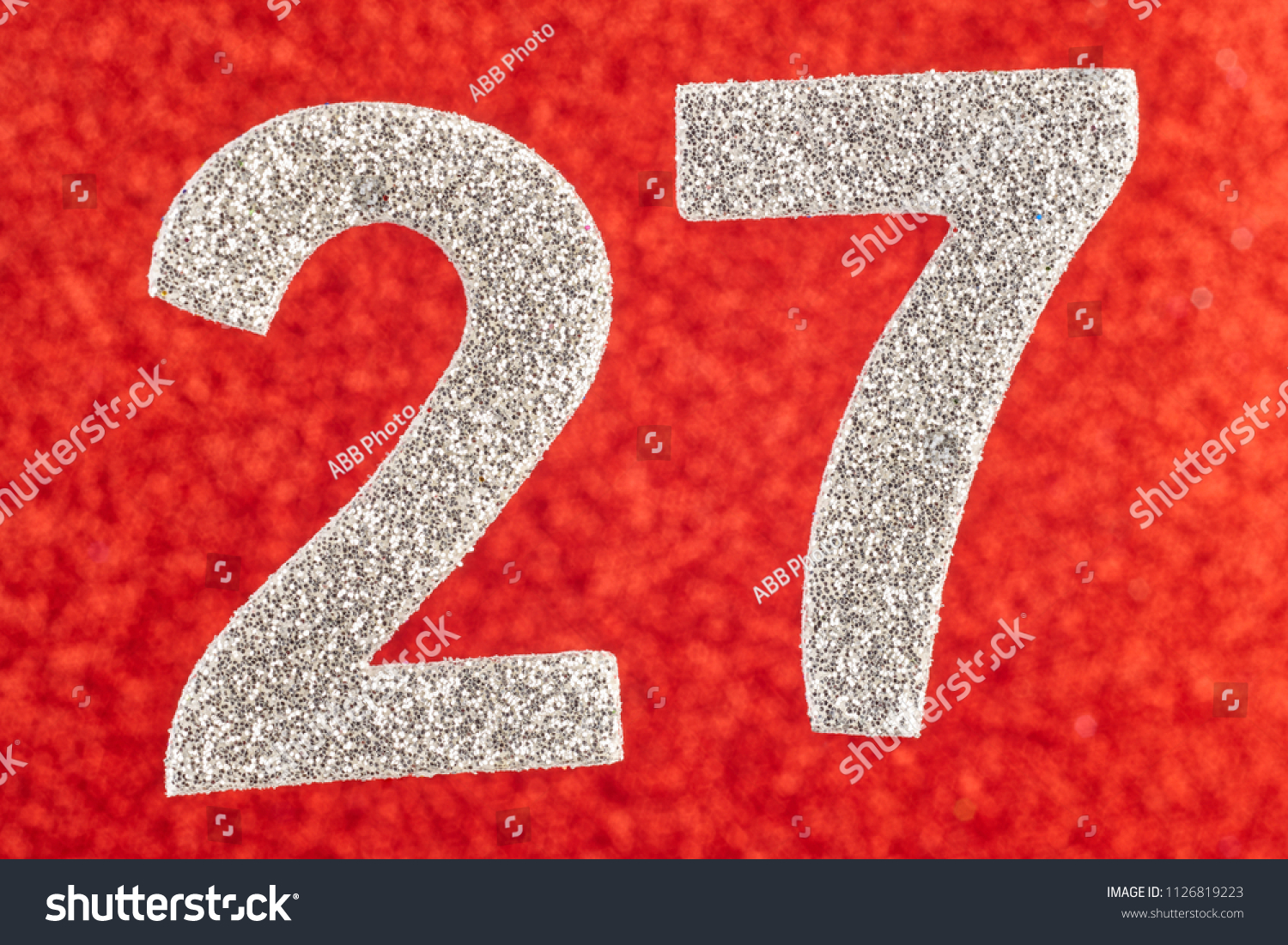Number twenty-seven silver color over a red background. Anniversary. Horizontal #1126819223