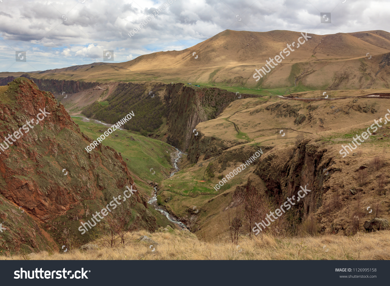 Mountain landscape. The region of Elbrus, Karachay-Cherkessia, Russia. The gorge of the Malka River, the Gyly-Su tract.
The place of exit of curative mineral springs and volcanic rocks. #1126995158