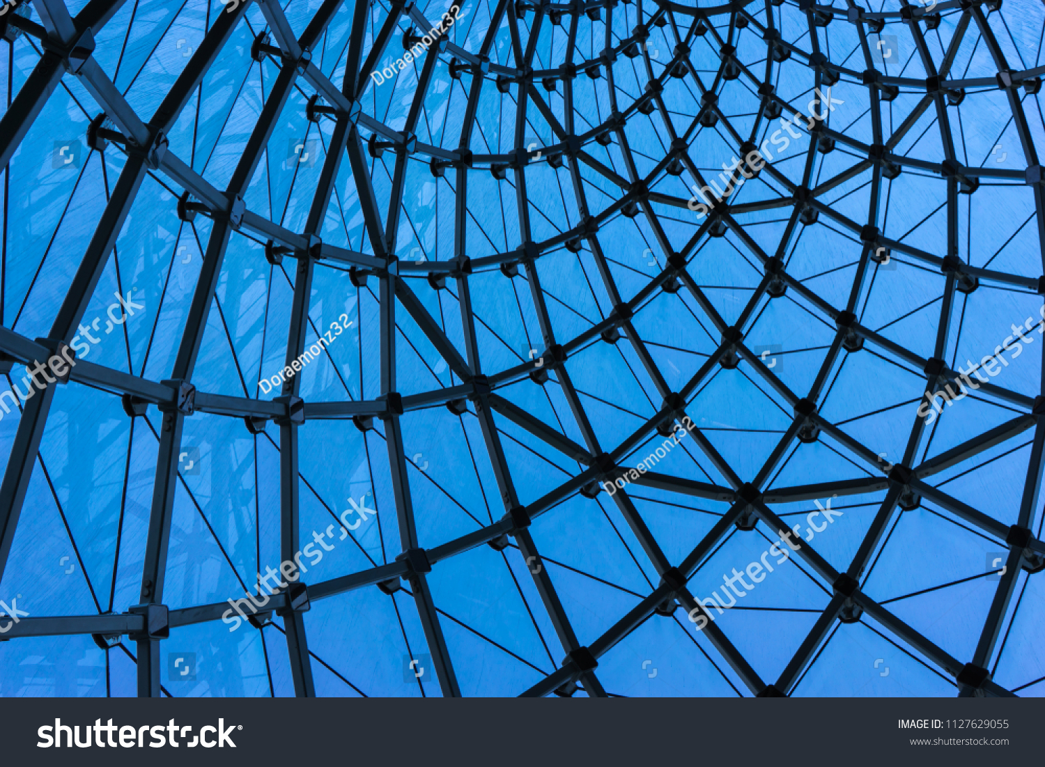 Structural glass facade curving roof of fantastic office building. Modern and Contemporary architectural fiction with glass steel column.Abstract architecture fragment. #1127629055