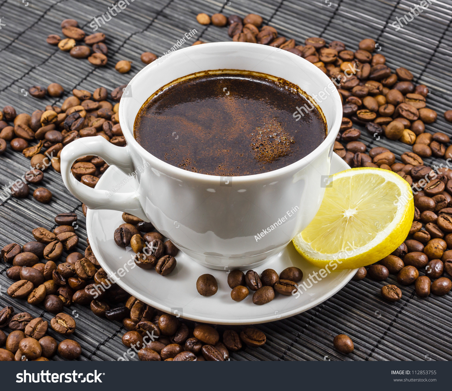 Warm cup of coffee with a coffee beans on background #112853755