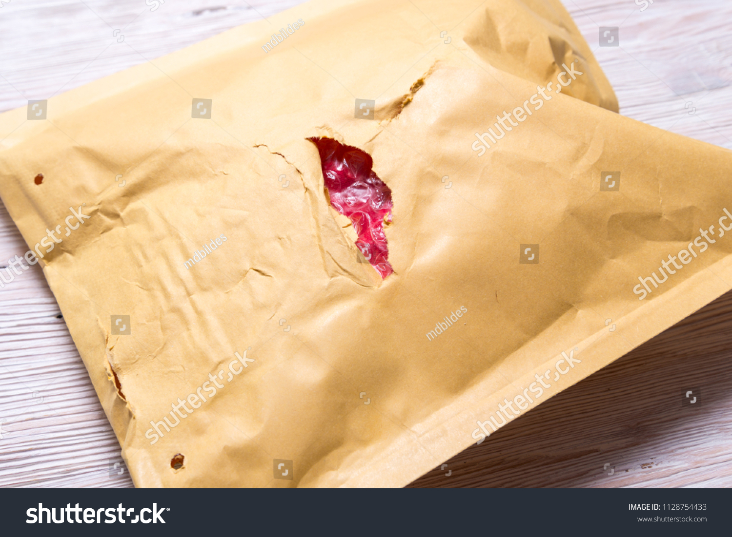 Damaded brown paper padded envelope. #1128754433