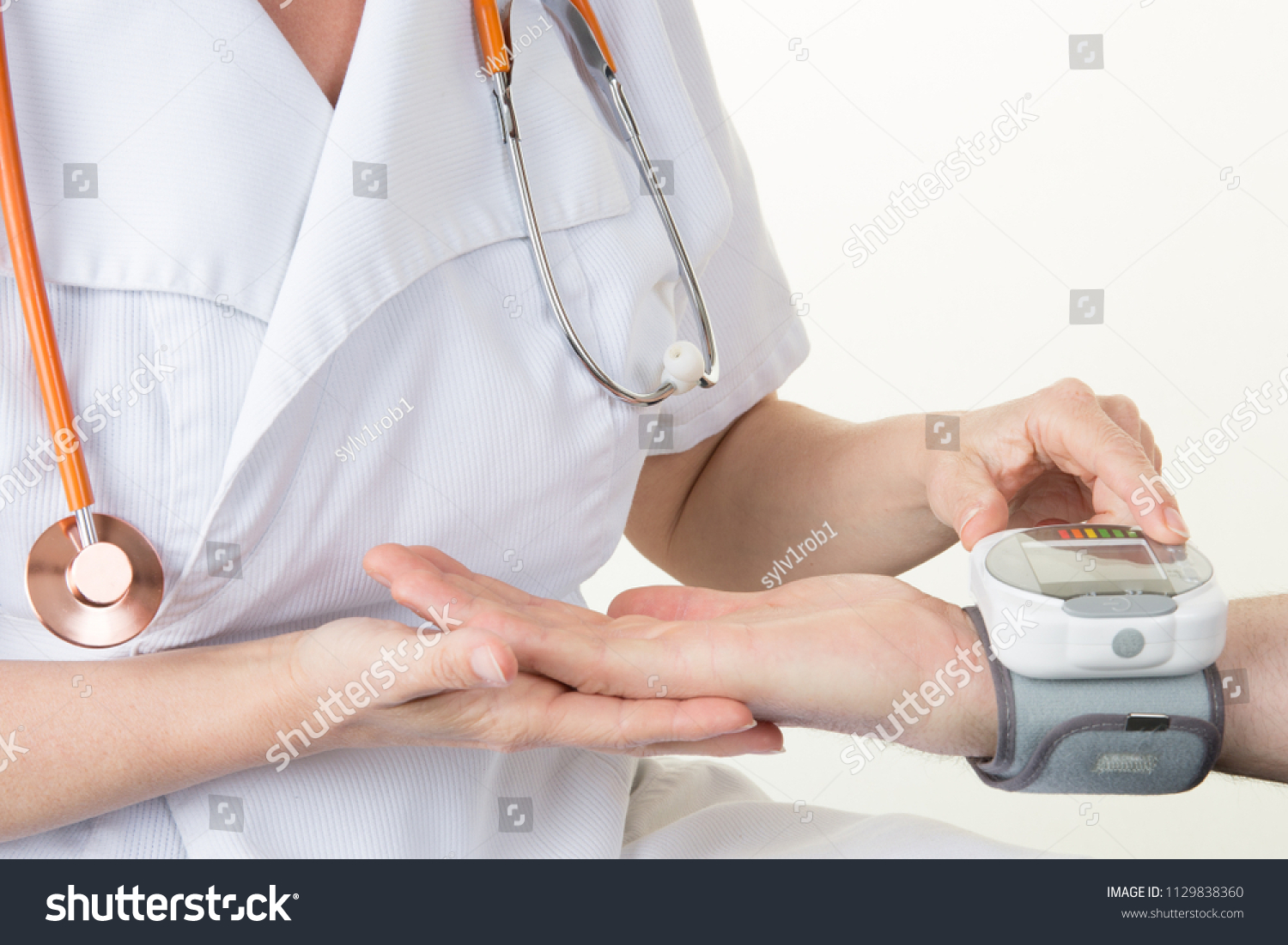 doctor woman measuring arterial blood pressure in hospital and medicine concept #1129838360