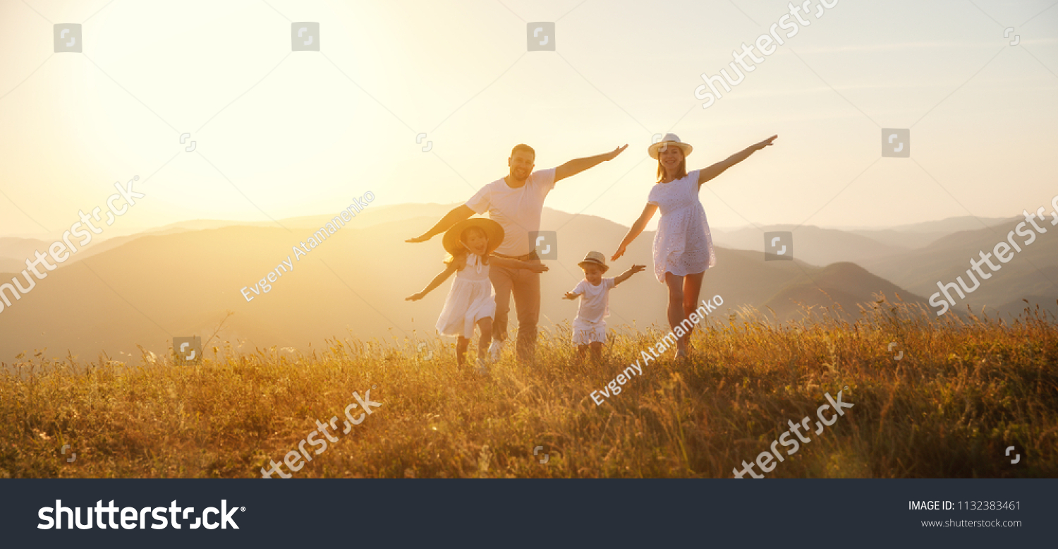 Happy family: mother, father, children son and  daughter on nature  on sunset #1132383461