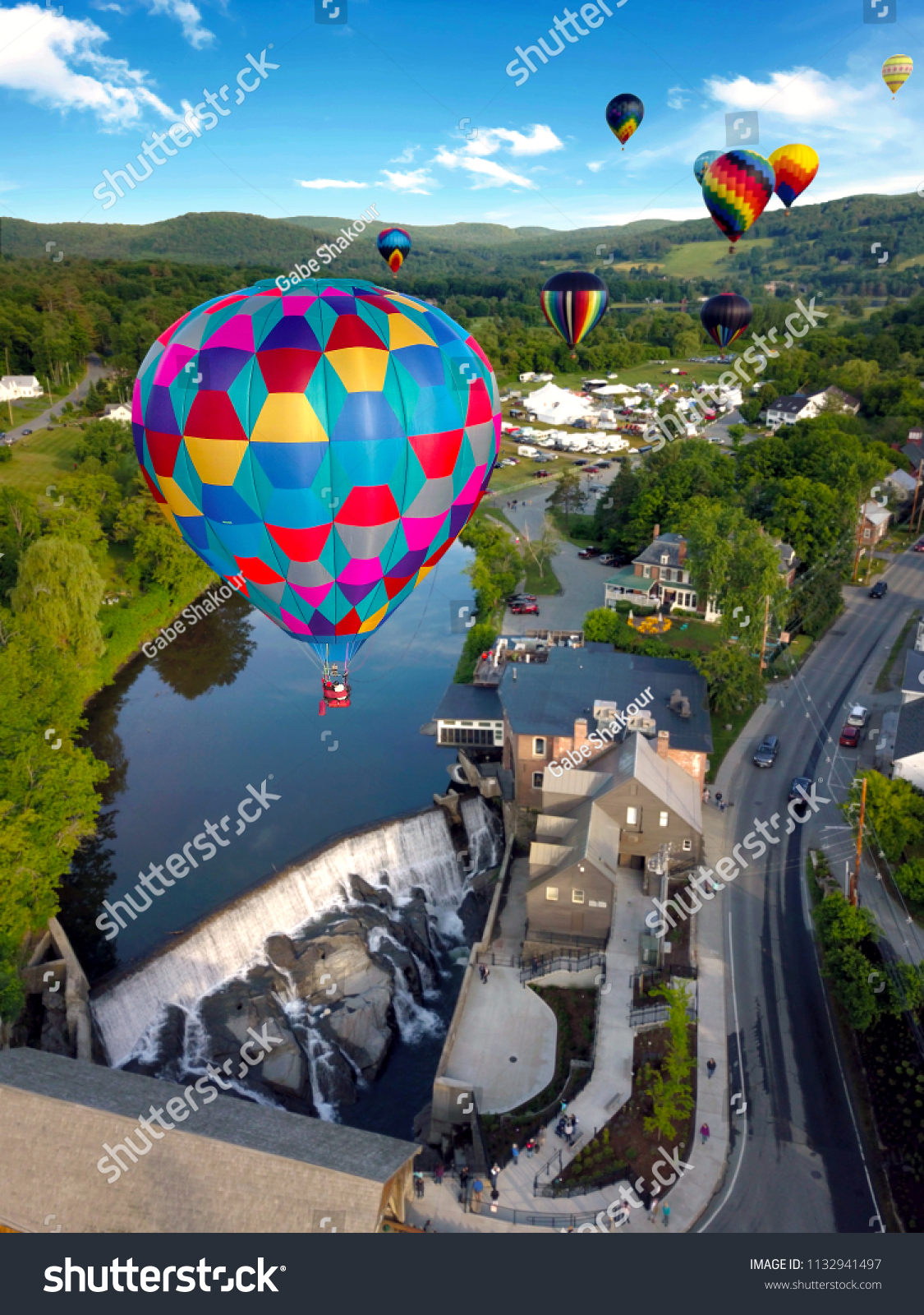 Floating above the ground through a hot air balloon festival. #1132941497