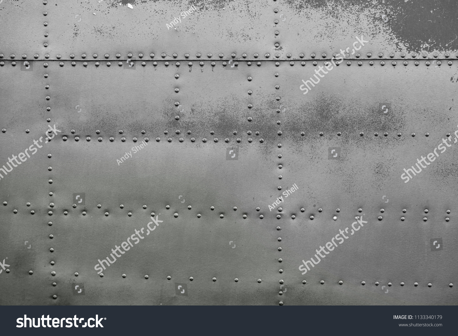 Old silver metal surface of the aircraft fuselage with rivets #1133340179