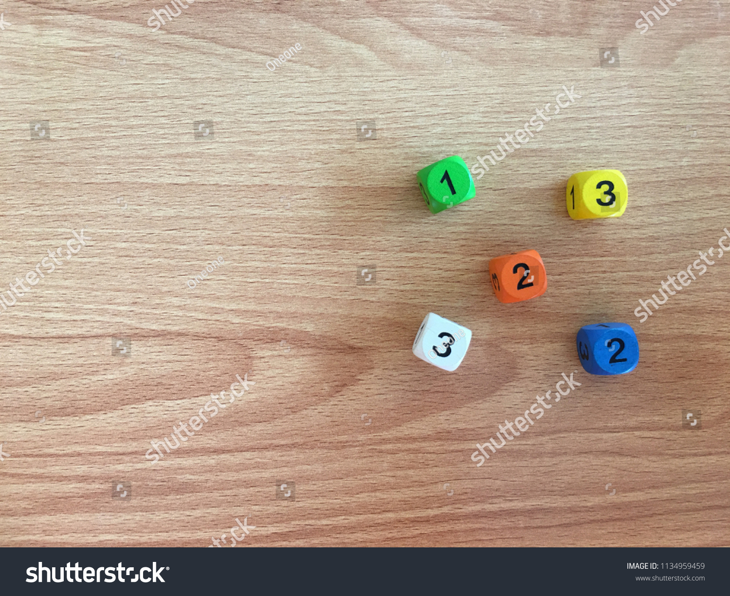 white, yellow, orange, green,blue dics on wooden table from above. Gambling devices. Game of chance concept. #1134959459