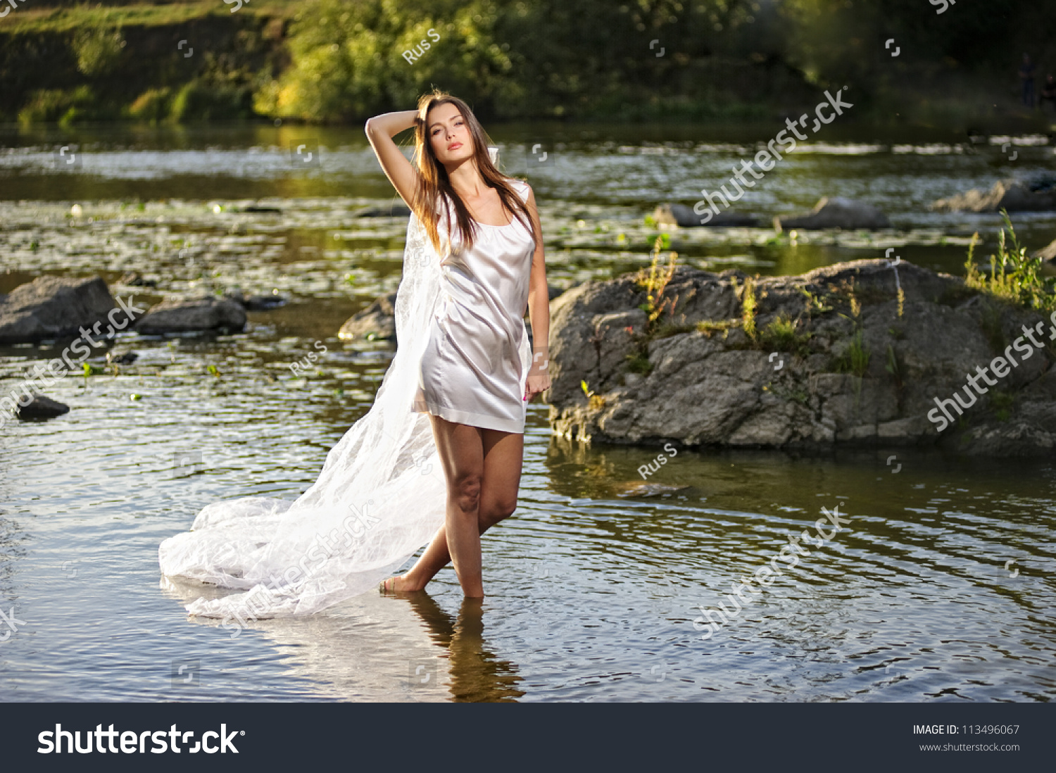 Portrait of yang sexy woman on sunset river. #113496067