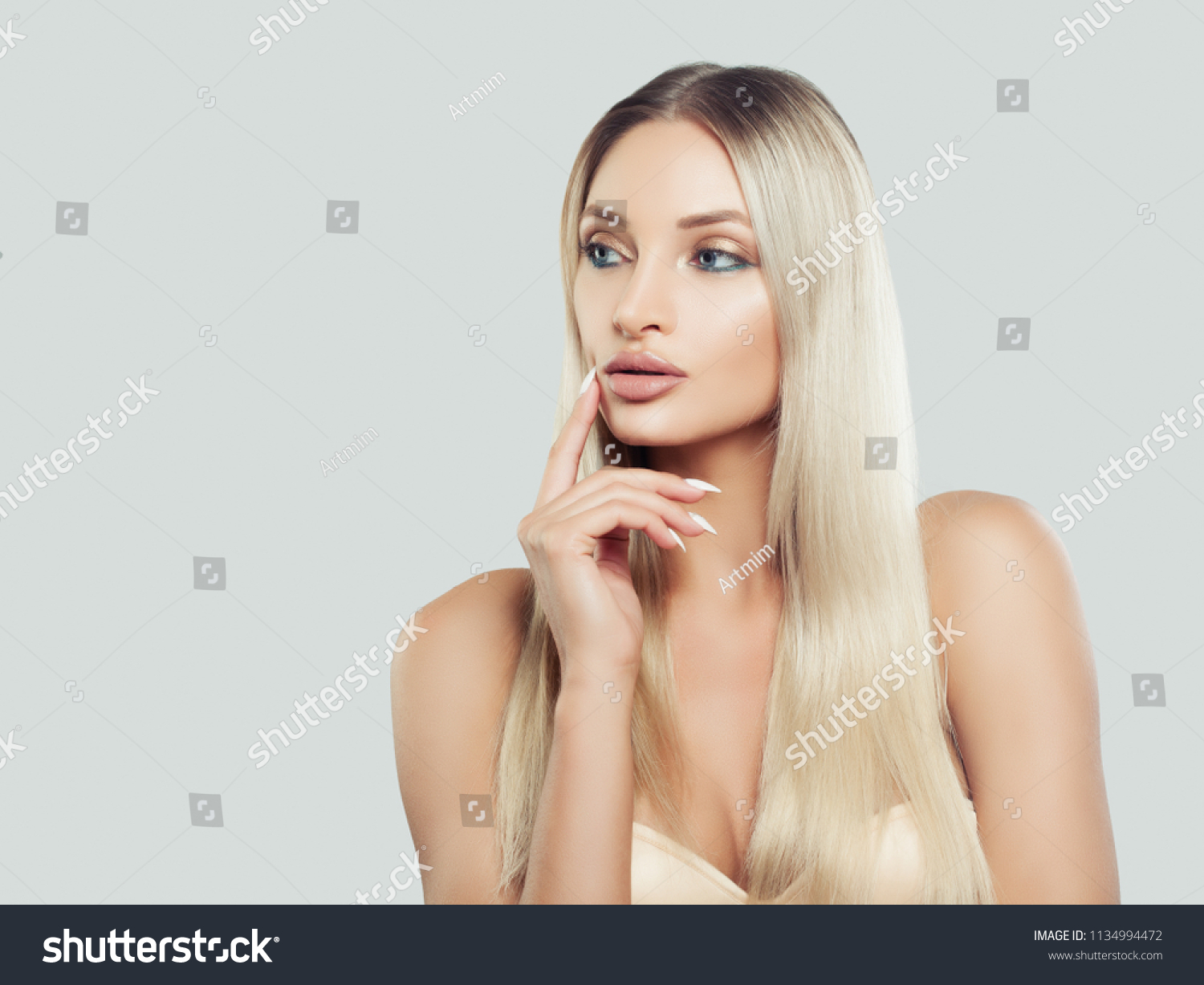 Thinking Woman with Clean Fresh Skin and Blonde Hair on Background with Copy space. Facial treatment. Cosmetology, beauty, skin care and spa #1134994472