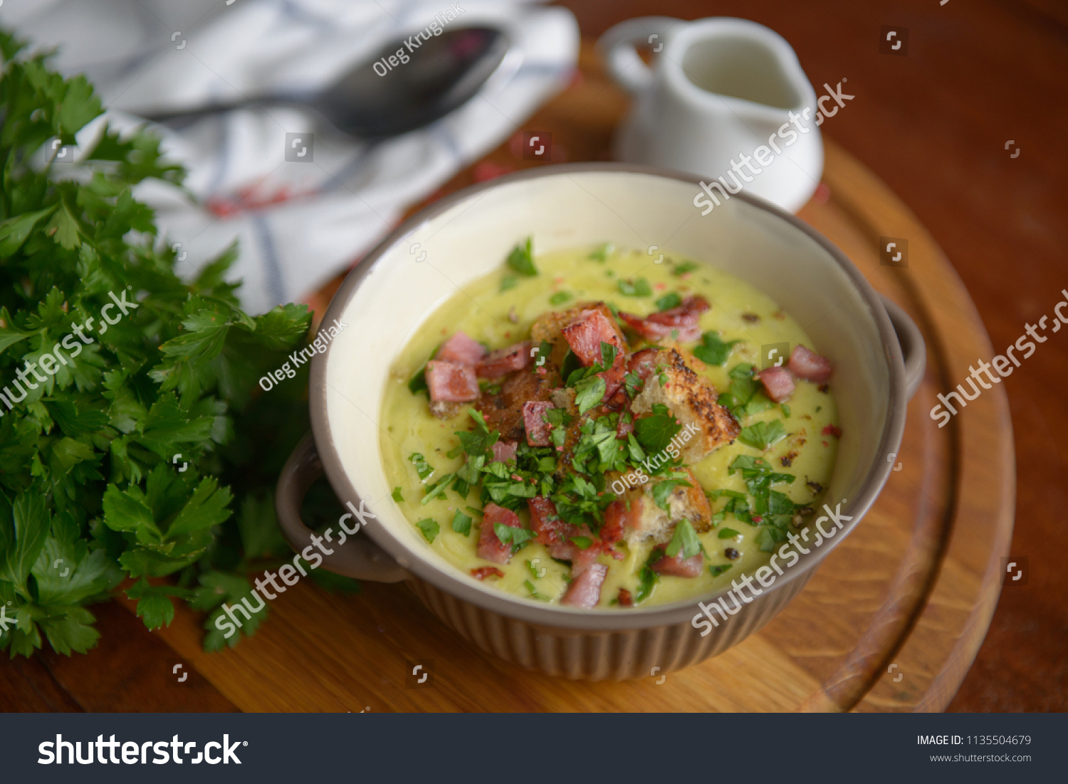 Fresh Soup with croutons and ham on a wooden table #1135504679