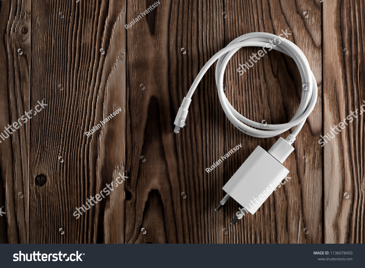 Cable phone chargers on wood background #1136078450