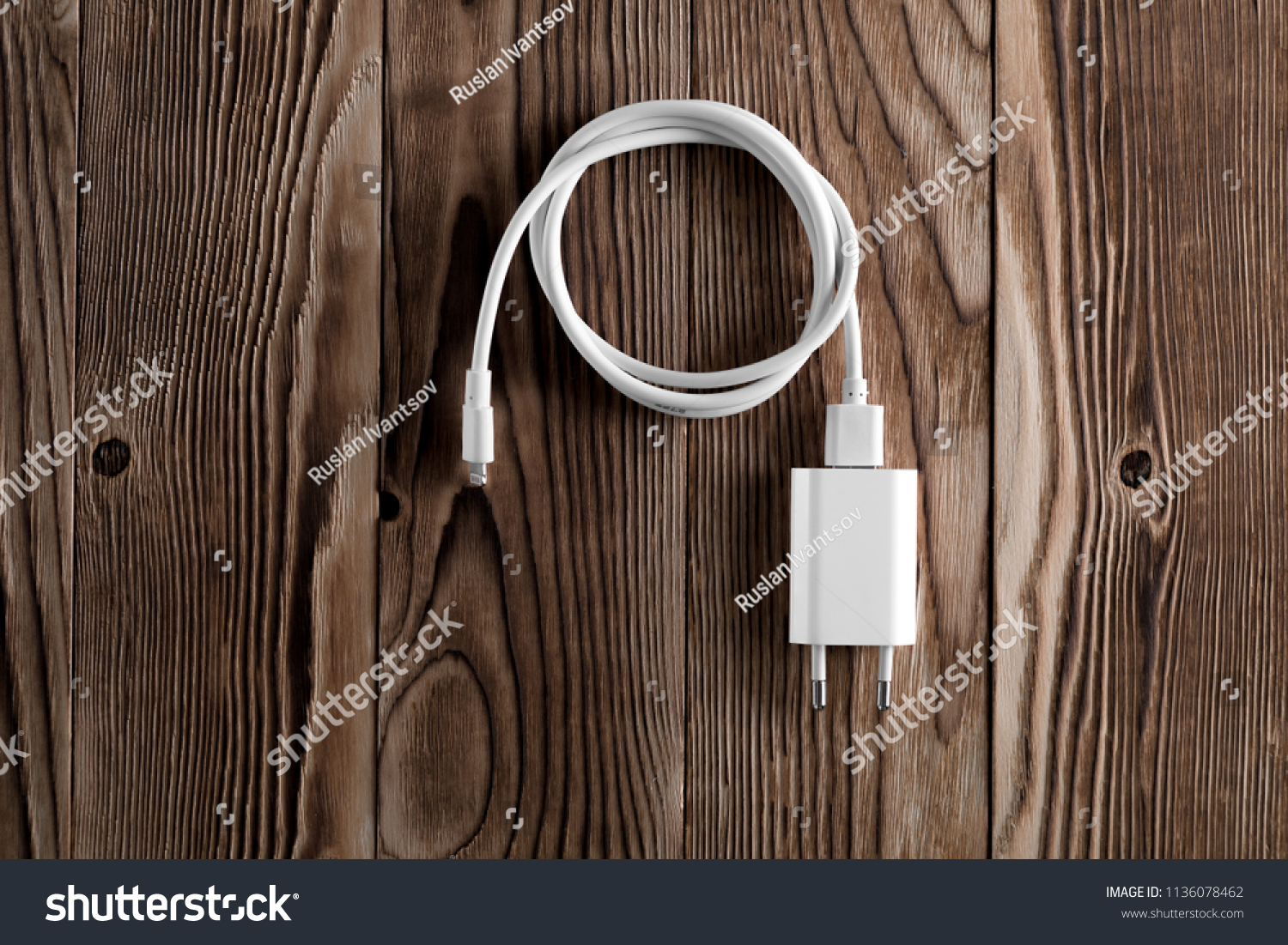 Cable phone chargers on wood background #1136078462