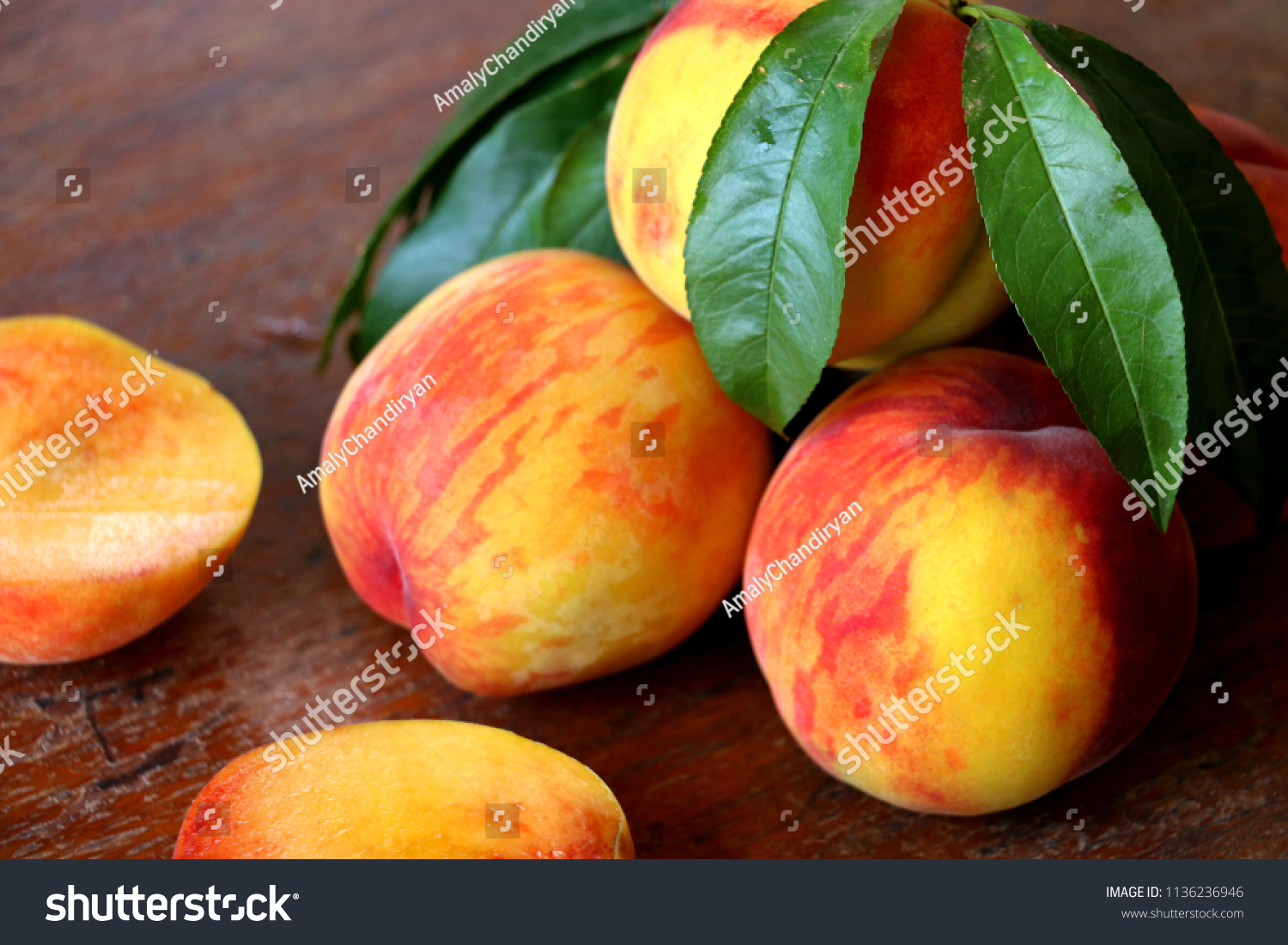 
Peach fruit with leaf  on a wooden background. #1136236946