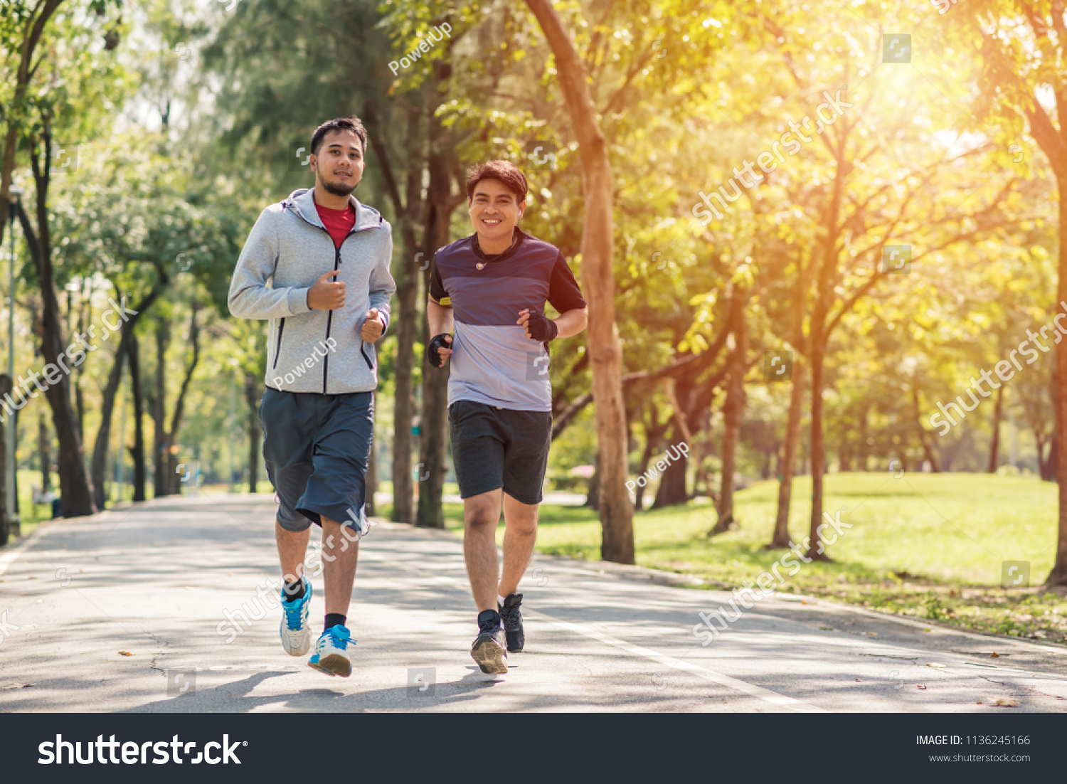 two sportsmen jogging in park in the morning #1136245166