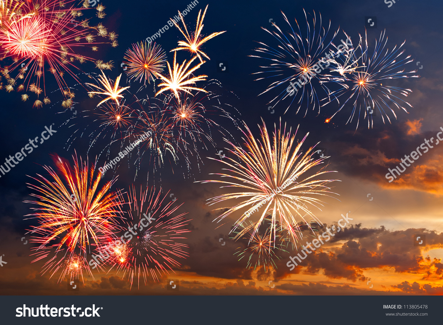 Beautiful colorful holiday fireworks in the evening sky with majestic clouds,  long exposure #113805478