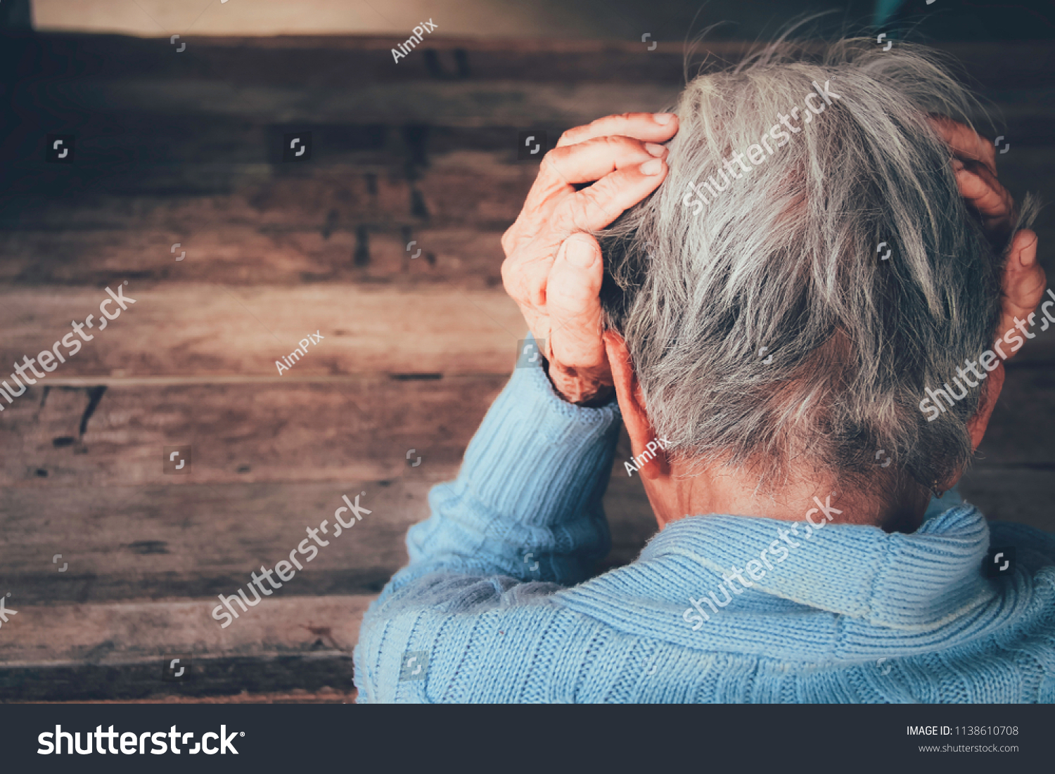 Adult woman has a headache. She sitting head in hands on dark black room. Concept dramatic loneliness, sadness, depression, sad emotions, cry, disappointed,healthcare, pain. #1138610708
