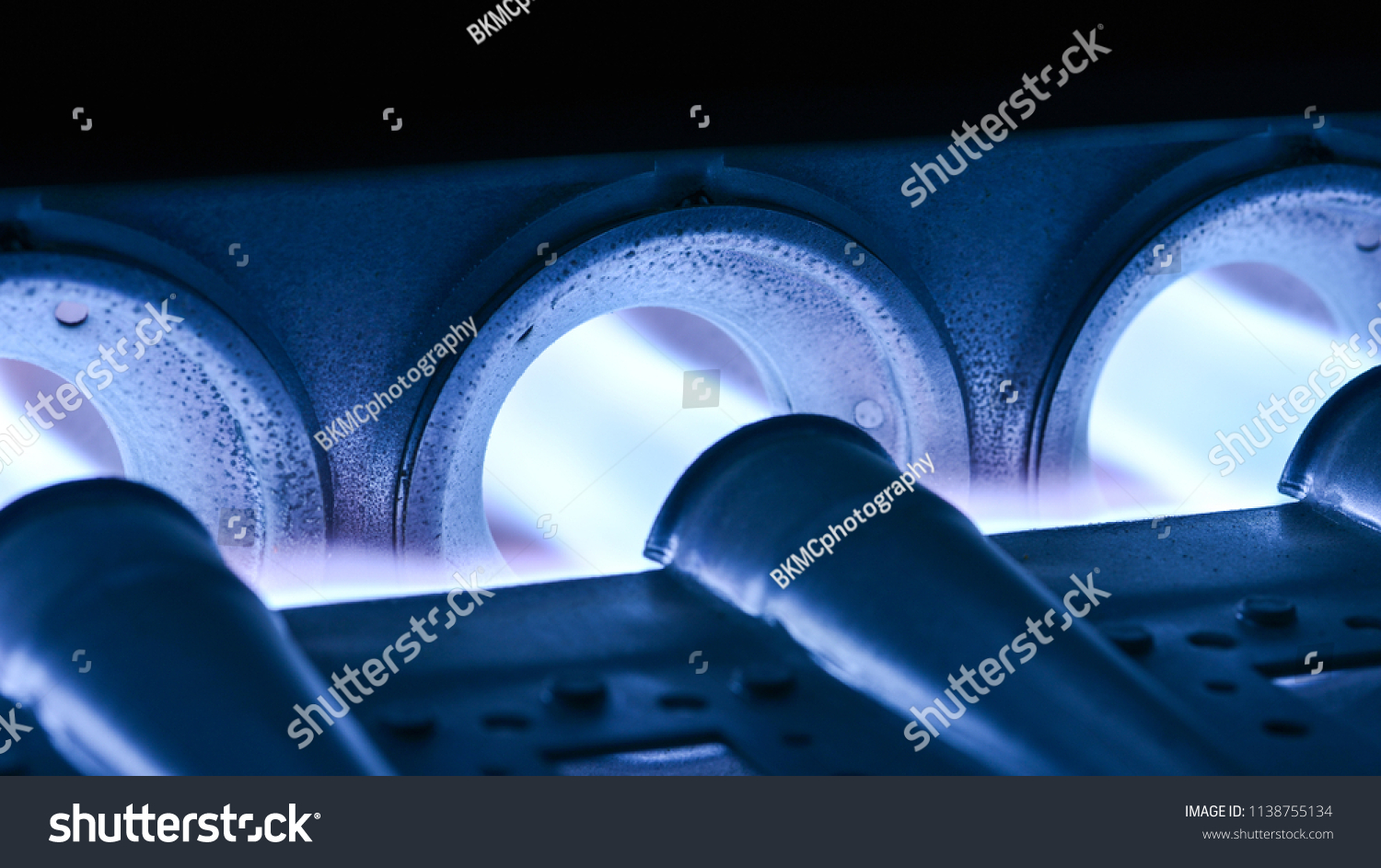 Closeup Shot Of Home Furnace Burner Ignited With Crimson Blue Flame #1138755134