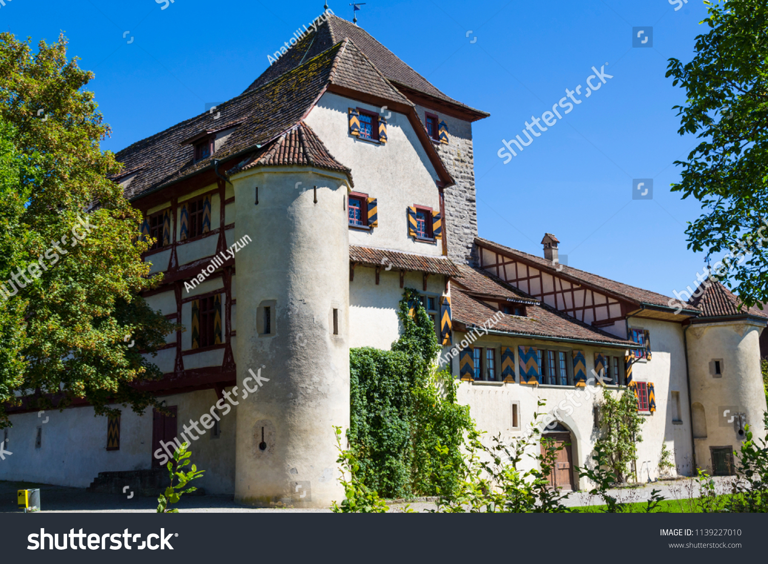 Ancient Hegi castle in the town Winterthur, Switzerland. General view, outside on a blue sky background in a summer day. Tourist attraction, tourist destination. #1139227010