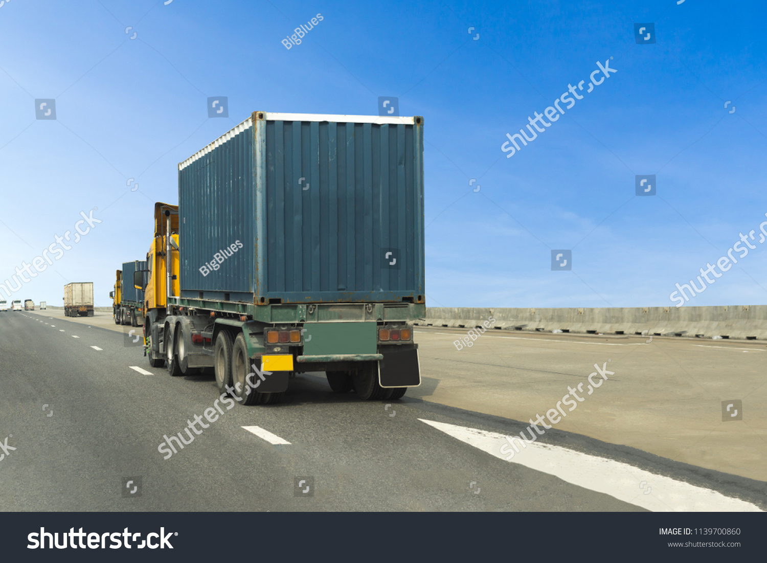 Truck on highway road with blue container, transportation concept.,import,export logistic industrial Transporting Land transport on the asphalt expressway with blue sky #1139700860