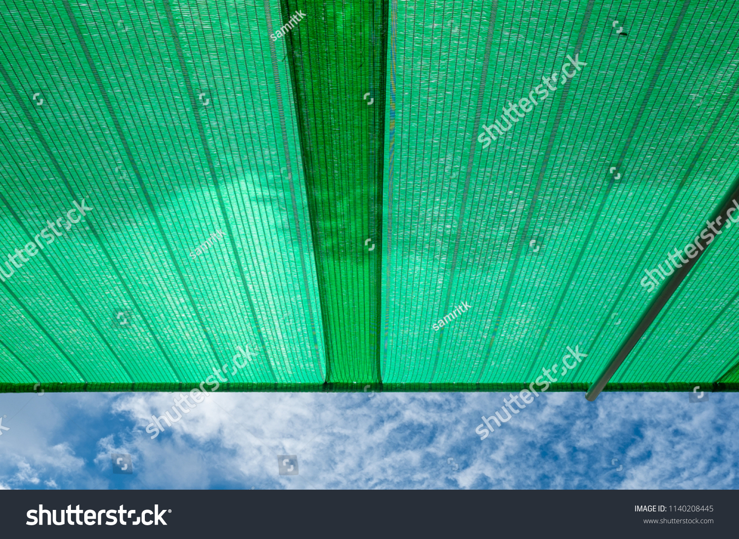 Green shading net roof against with blue sky background #1140208445