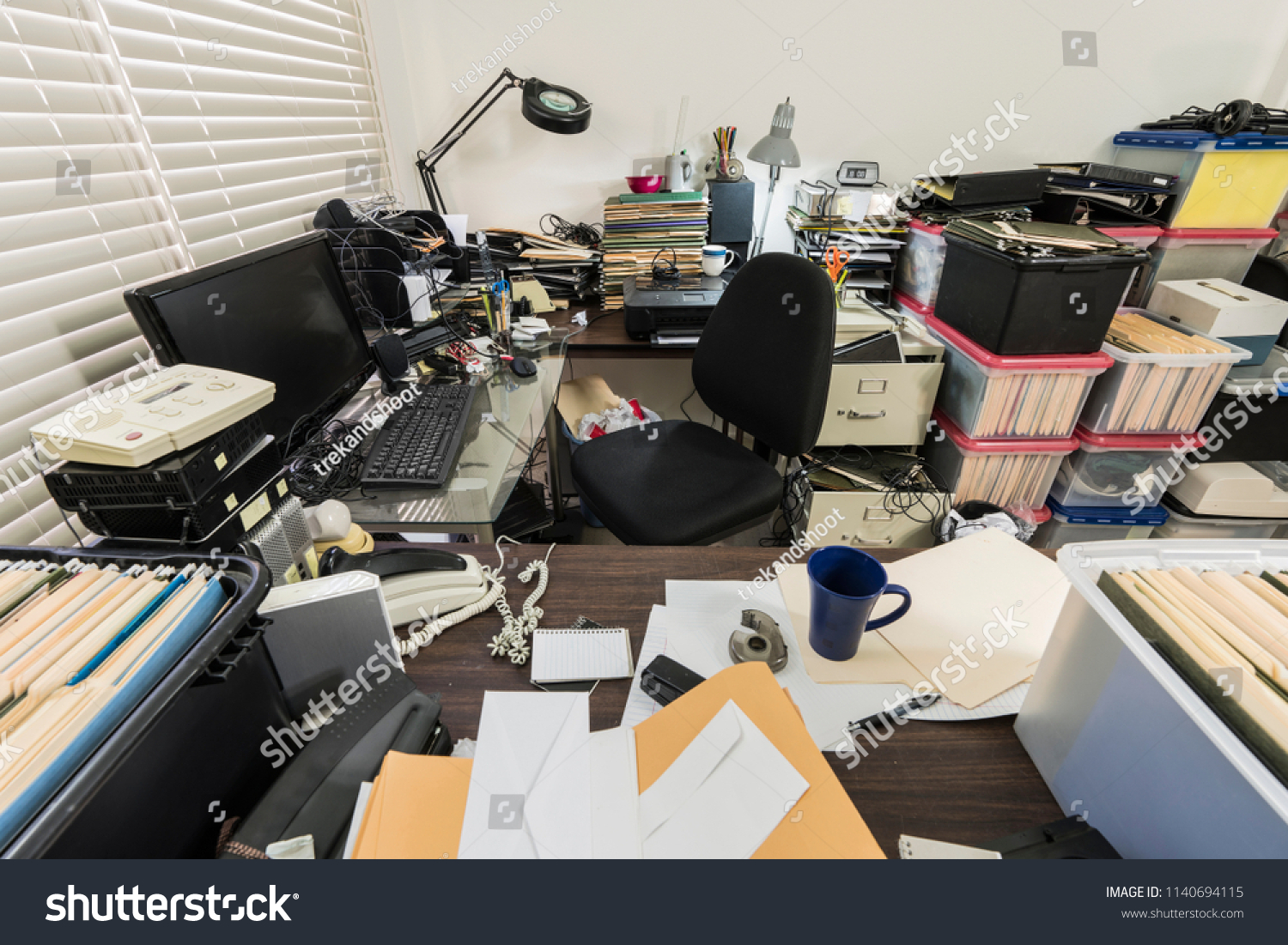 Messy business office with piles of files and disorganized clutter. #1140694115