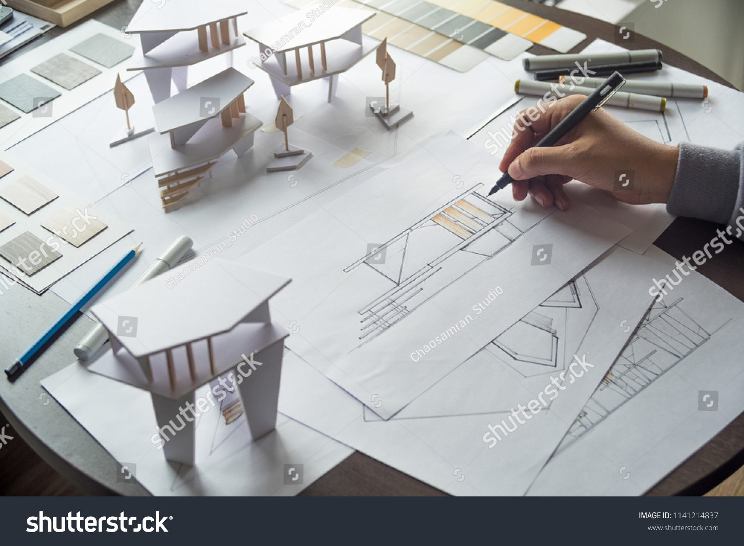 architect design working drawing sketch plans blueprints and making architectural construction model in architect studio #1141214837