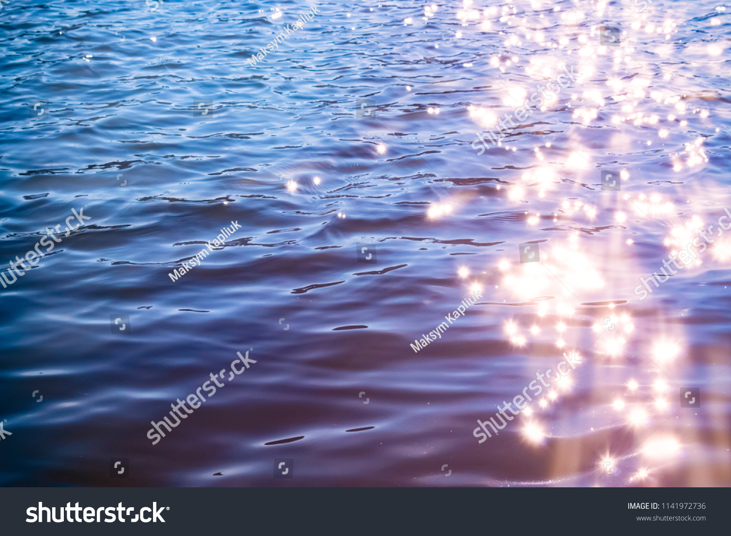 Sunlight twinkling off river water with small waves. Calm summer evening. Colorful background #1141972736
