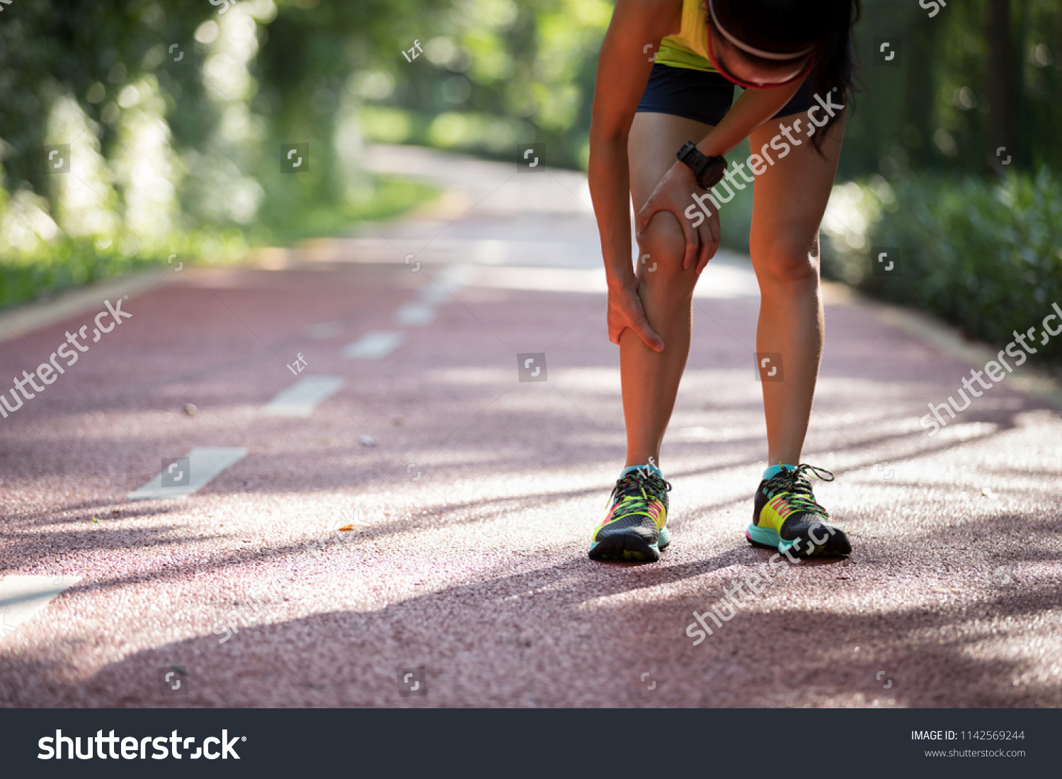 Female runner suffering with pain on sports running knee injury 
 #1142569244