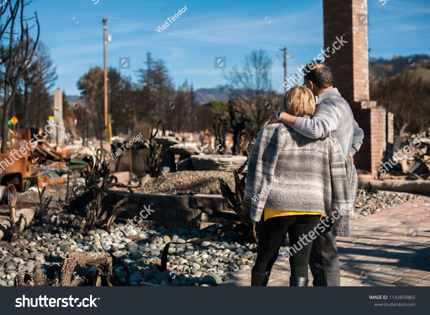 Man and his wife owners, checking burned and ruined of their house and yard after fire, consequences of fire disaster accident. Ruins after fire disaster. #1143859865