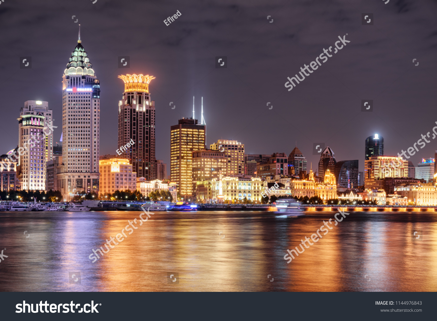 Amazing night view of Puxi skyline in Shanghai, China. Modern and old buildings of the Bund (Waitan) at historic center. Colorful city lights reflected in water of the Huangpu River. #1144976843