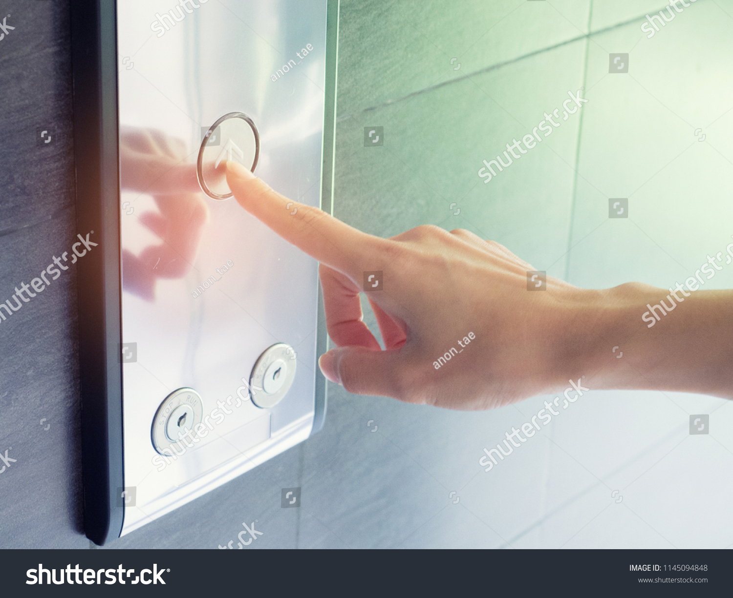 finger presses the elevator button,up and down button.woman pressing elevator button. finger presses the elevator button. #1145094848