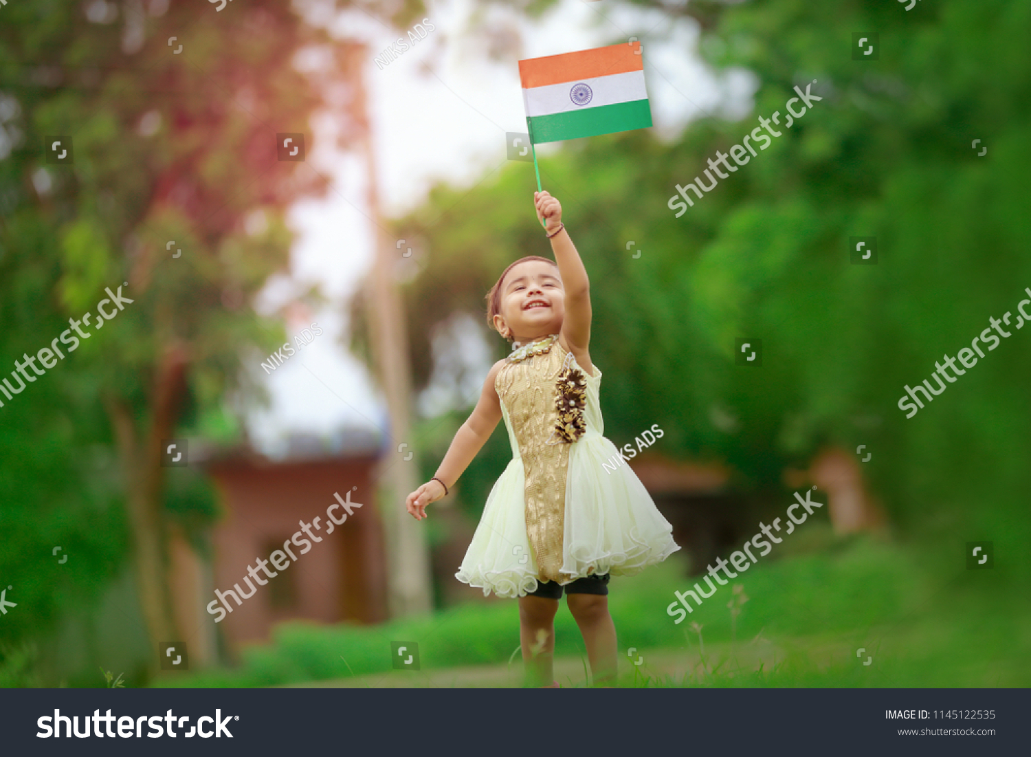 indian girl child holding indian flag #1145122535