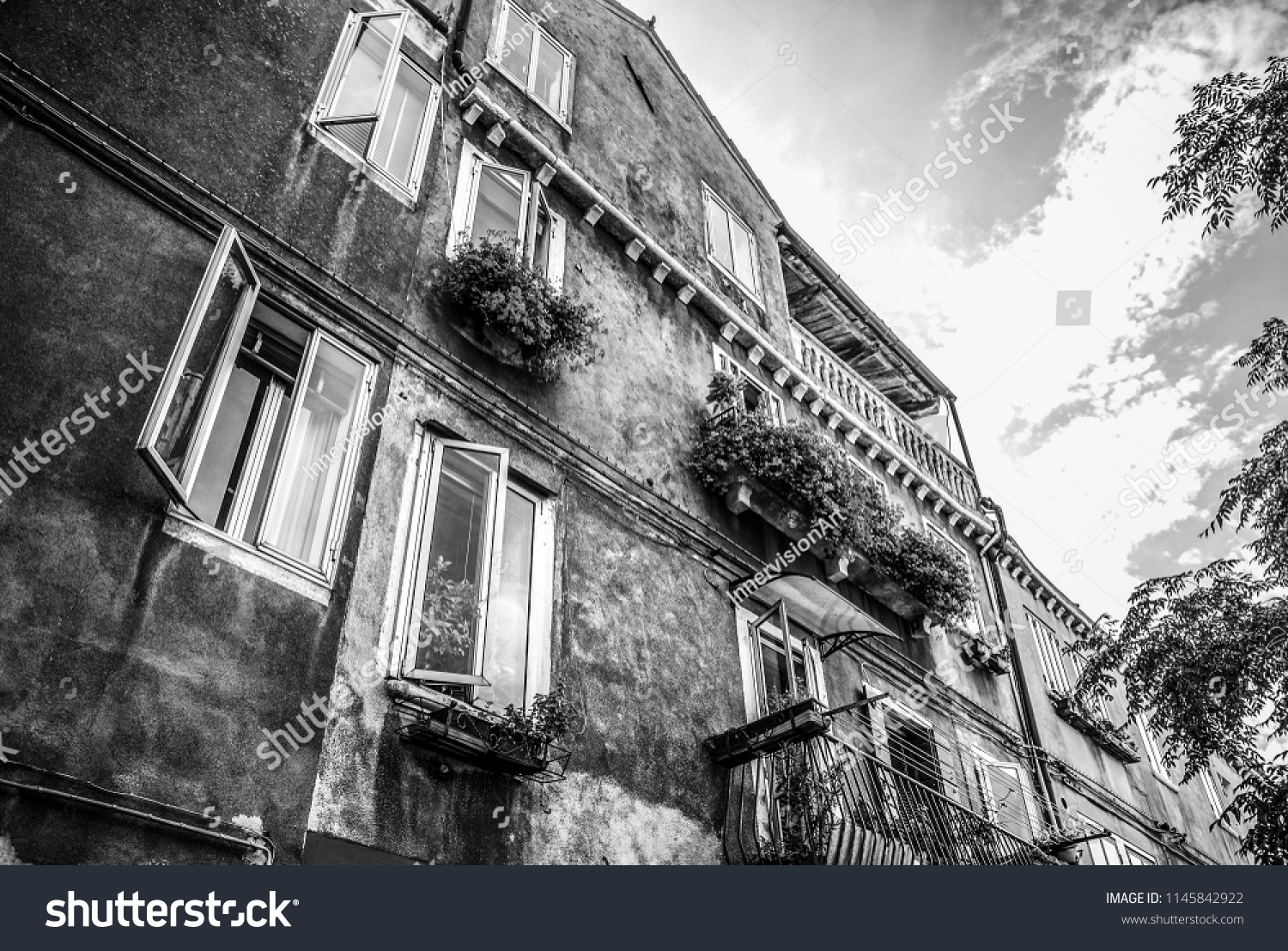 MURANO, ITALY - AUGUST 19, 2016: Famous architectural monuments and facades of old medieval buildings. Black-white photo on August 19, 2016 in Murano, Italy. #1145842922