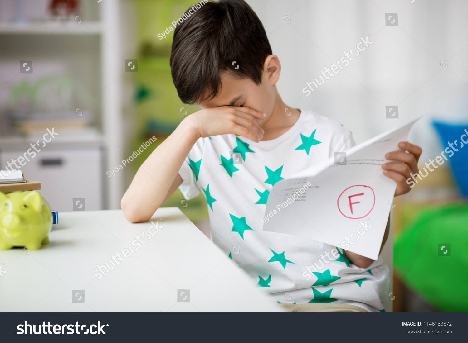 childhood, education and people concept - sad boy holding school test with f grade #1146183872