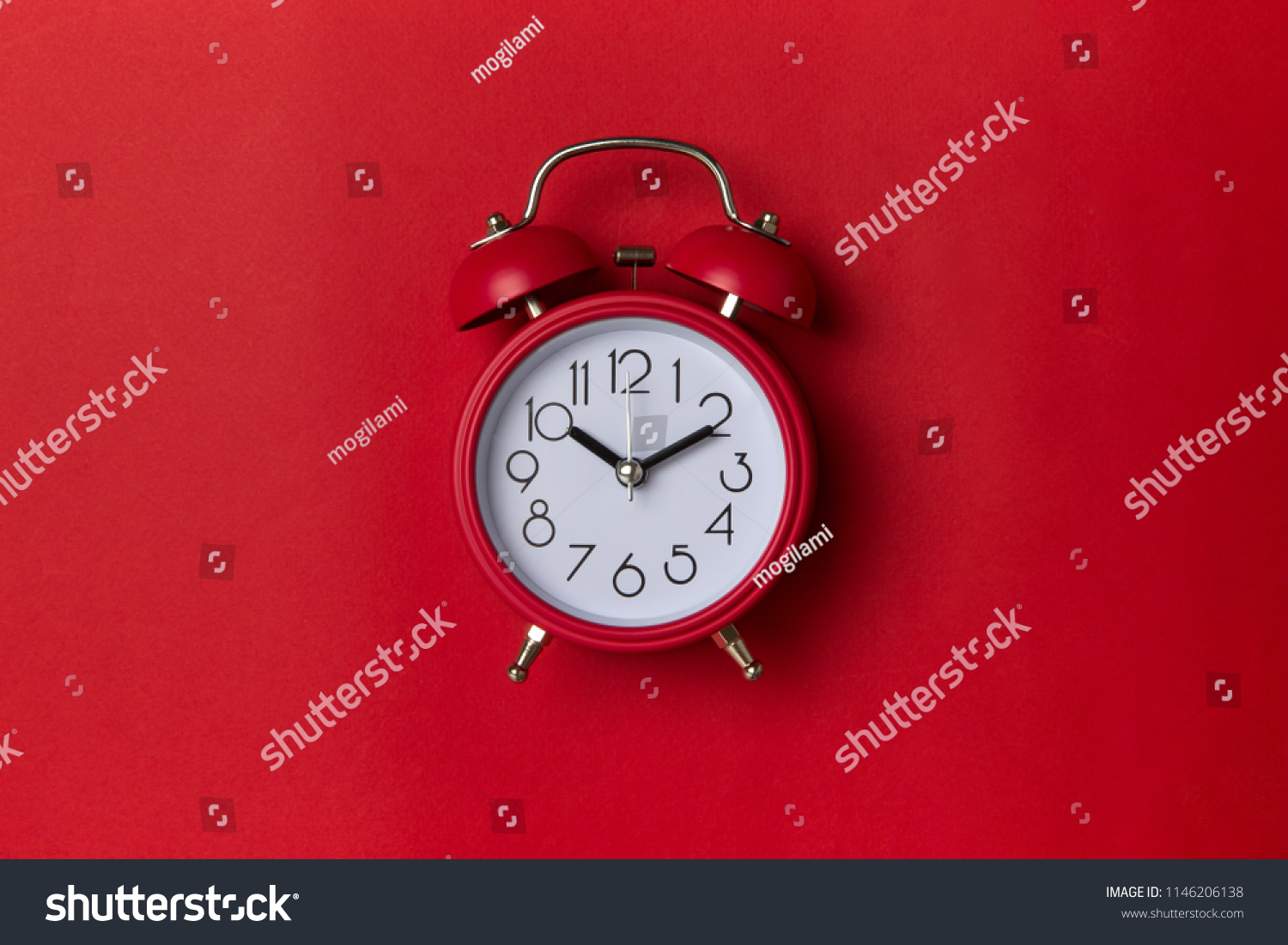 red alarm clock on red background. close up shot. top view. #1146206138