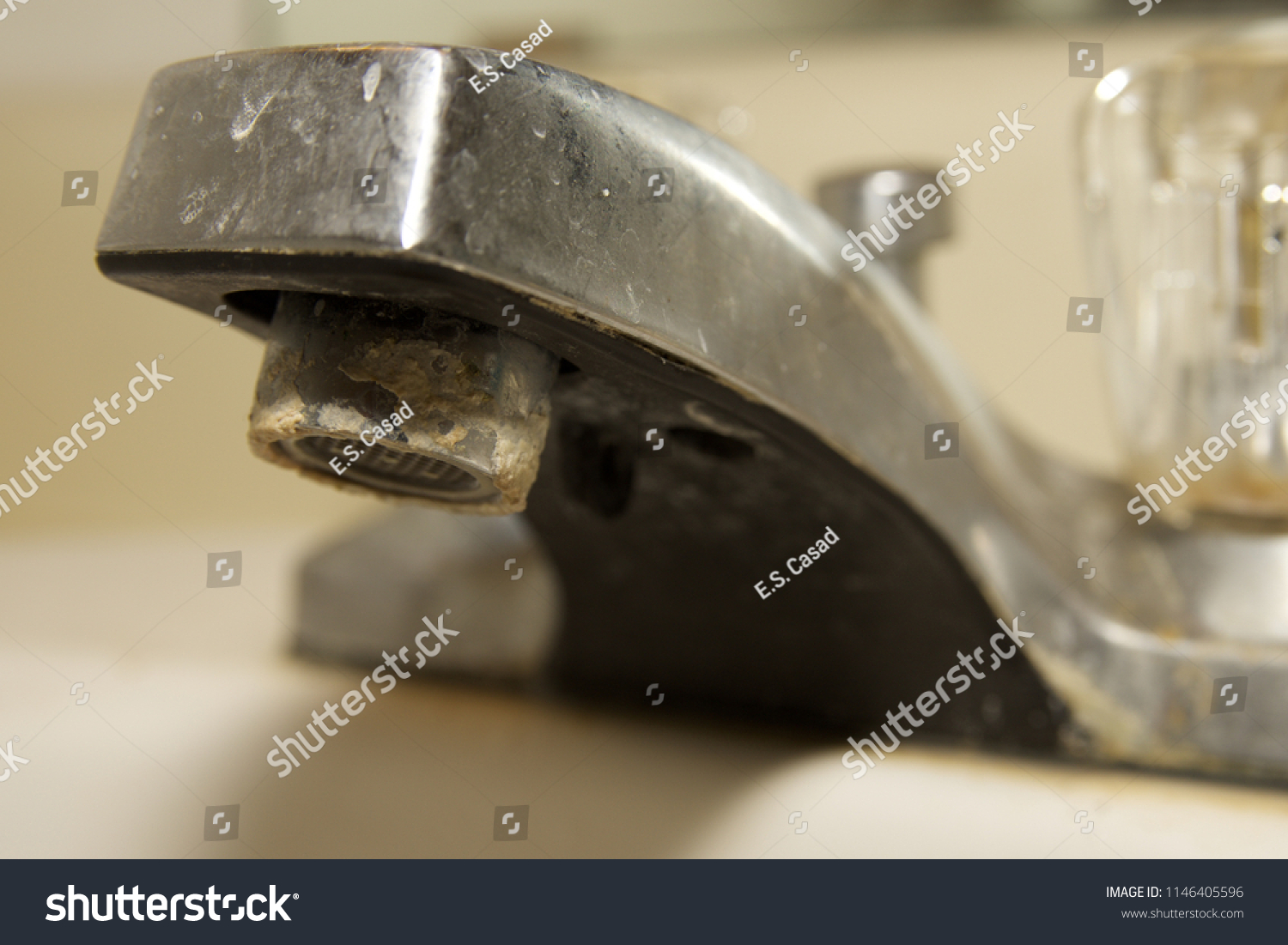 Minerals from hard water on bathroom sink faucet. #1146405596