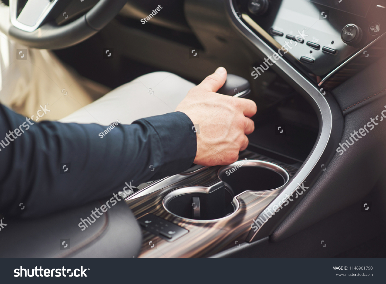 young man is a man behind the wheel of an arboreal car. #1146901790