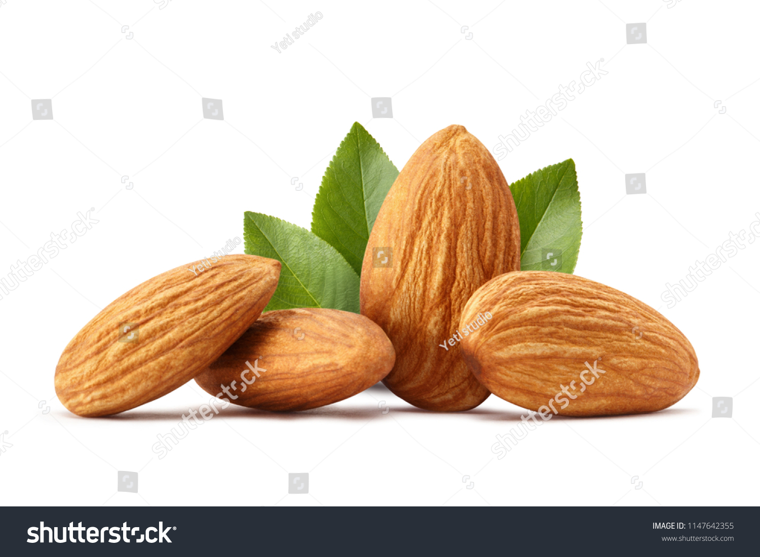 Close-up of almonds with leaves, isolated on white background #1147642355