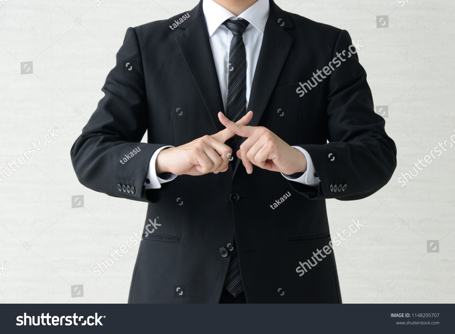 Business man with fingers crossed #1148205707