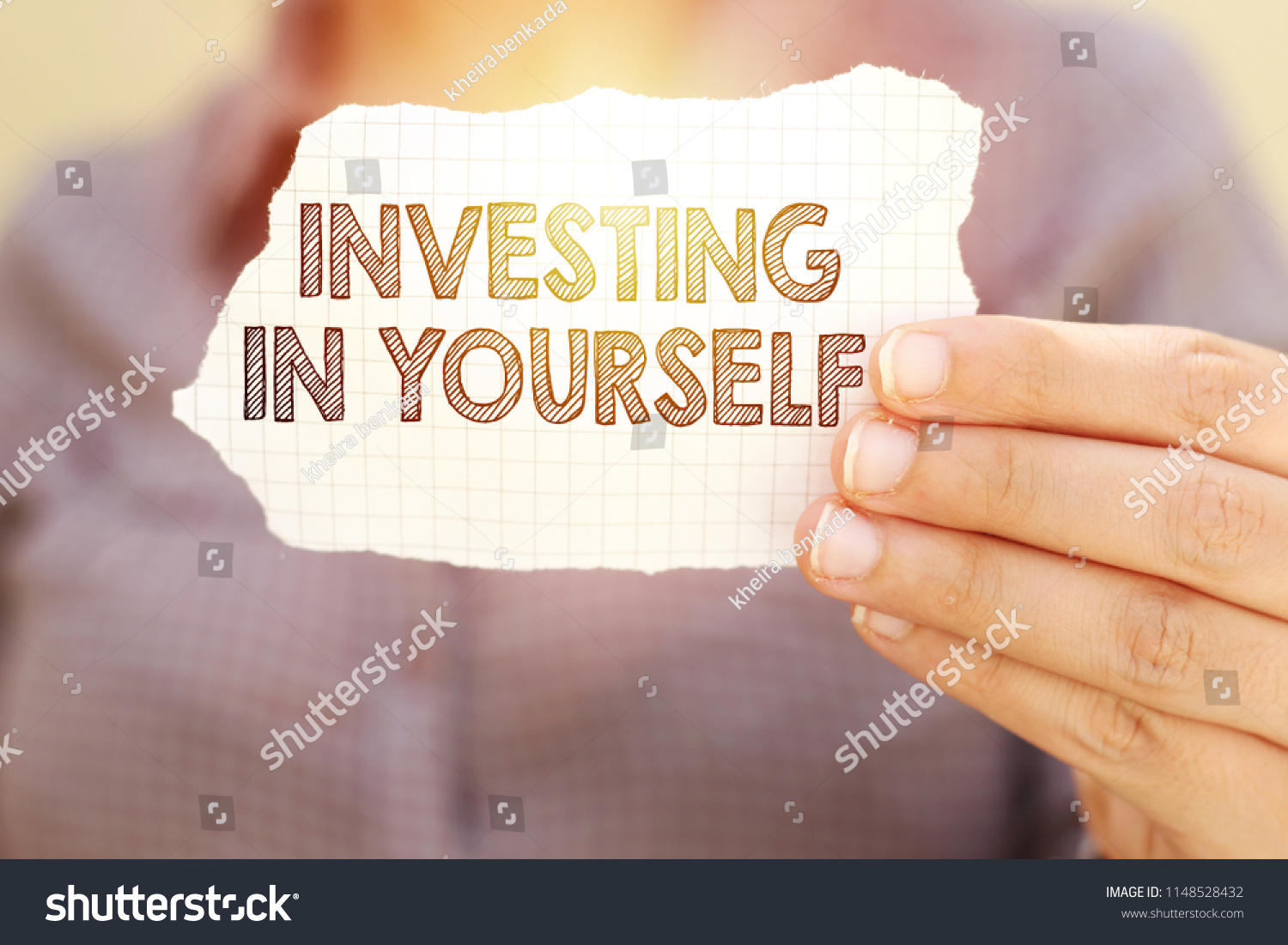 business woman holding tear paper with investing in yourself text #1148528432