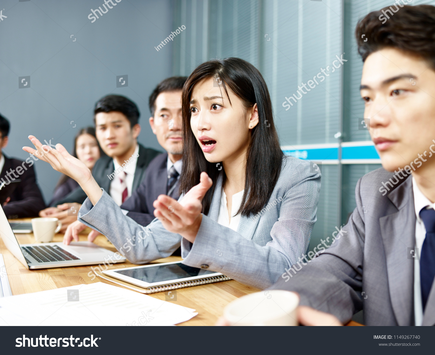young asian business woman executive engaging in a heated discussion during meeting. #1149267740