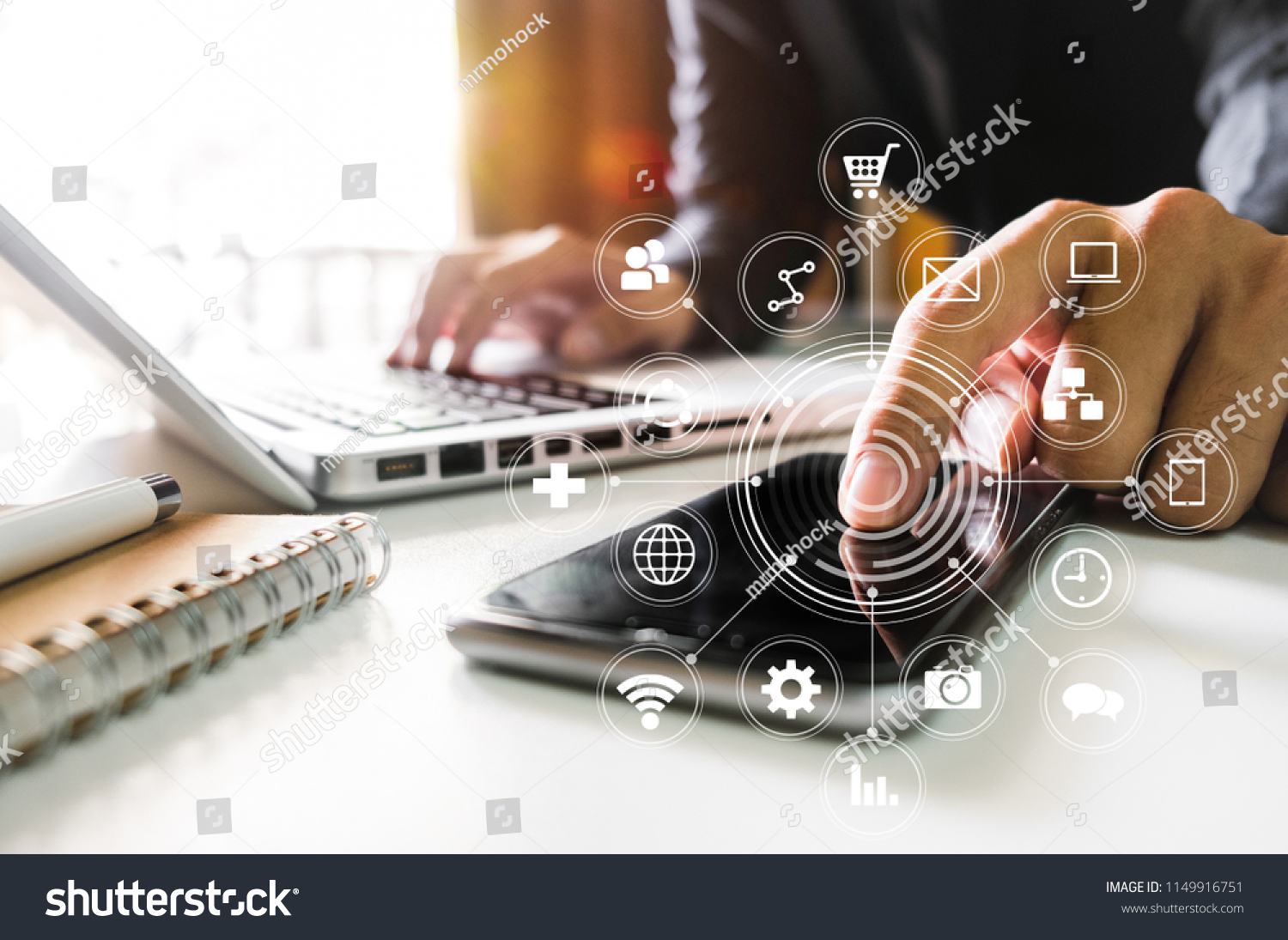 Digital marketing media in virtual screen.businesswoman hand working with mobile phone and modern compute with VR icon diagram at office in morning light 
 #1149916751