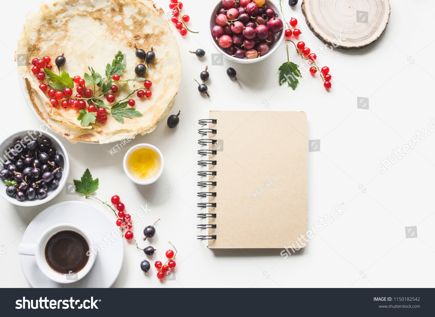 Breakfast from homemade pancakes and coffee with fresh berries of currants and gooseberries. With notepad recipe.  Flat lay, top view, copy space,  mock-up
 #1150182542