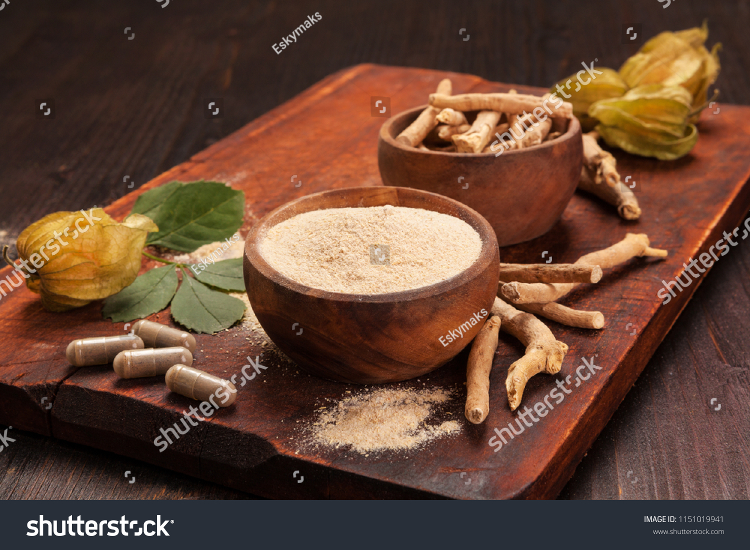 Roots and powder of Ashwagandha also known as Indian ginseng on wooden background. Hair loss, anti cancer, testosteron and depression benefits. #1151019941