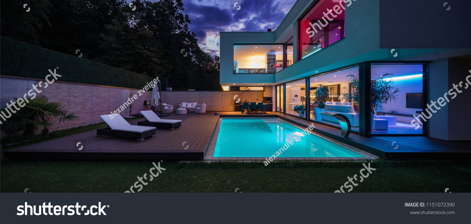 Modern villa with colored led lights at night. Nobody inside #1151072390