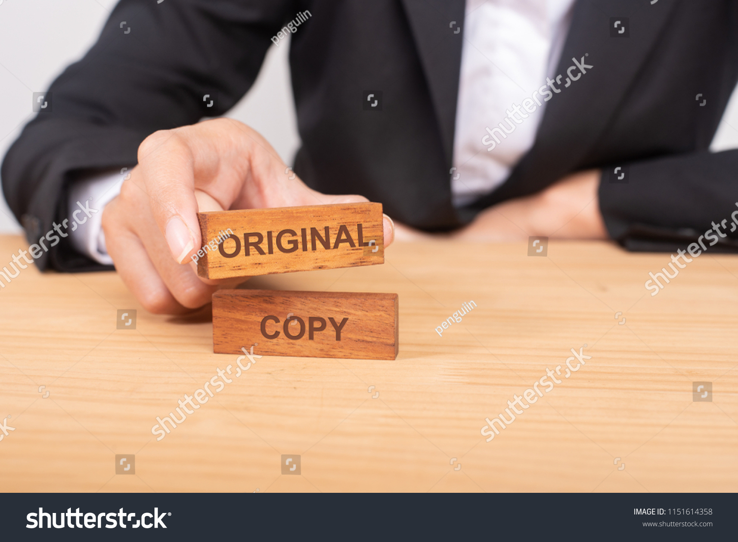 Hand of businessman choosing wood blog with icon and word Original and Copy. #1151614358