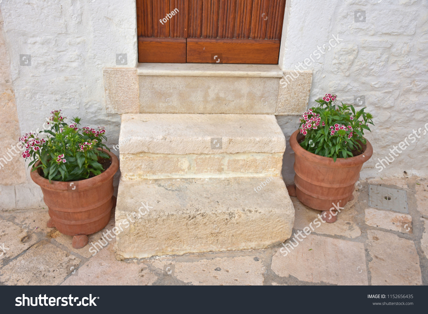 Italy, Puglia region, Locorotondo, 1 May 2018, a whitewashed village in the Itria valley, with its medieval historical center full of stairs, balconies, flowers, arches, frescoed churches, and details #1152656435