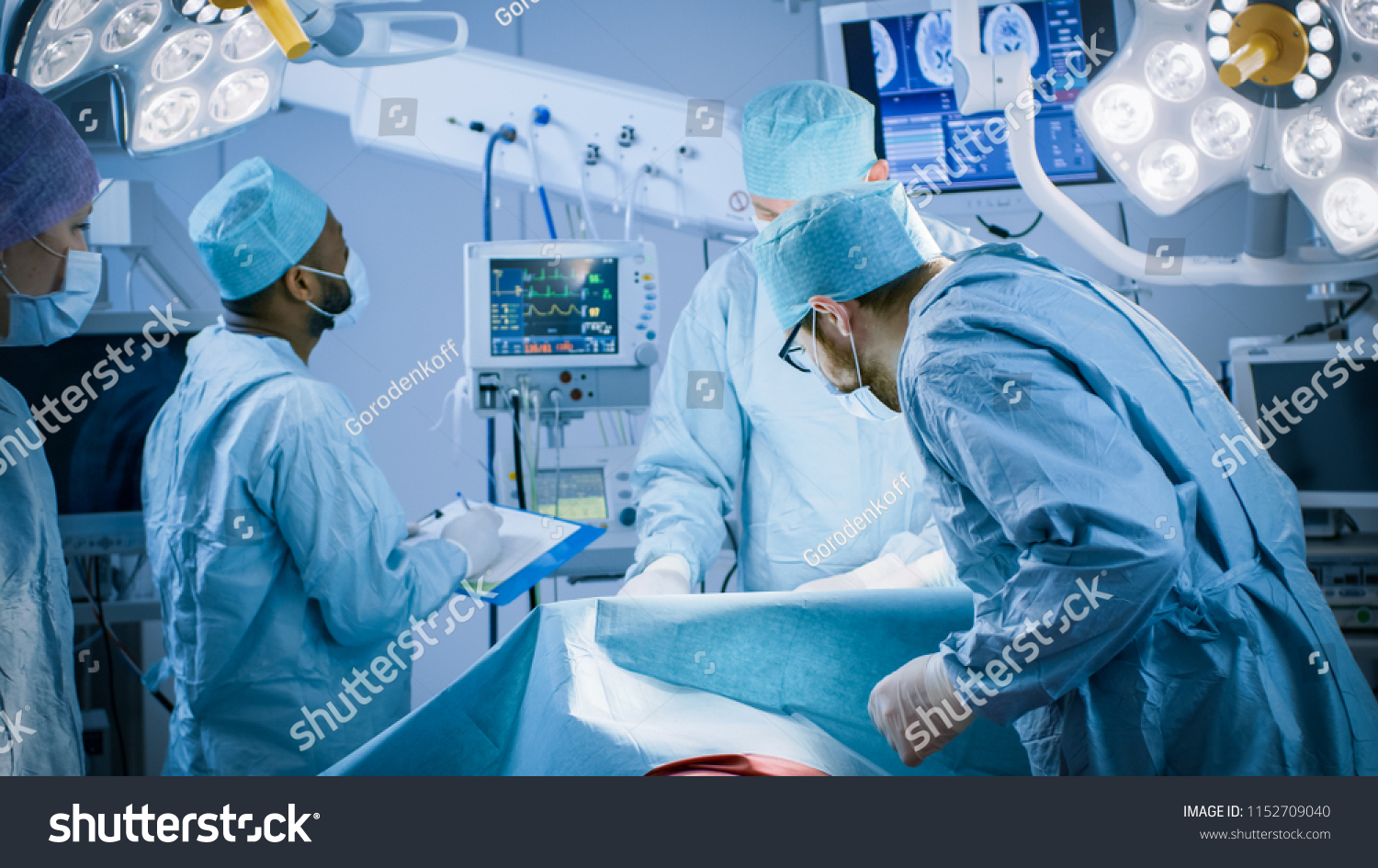 Diverse Team of Professional surgeon, Assistants and Nurses Performing Invasive Surgery on a Patient in the Hospital Operating Room. Real Modern Hospital with Authentic Equipment. #1152709040