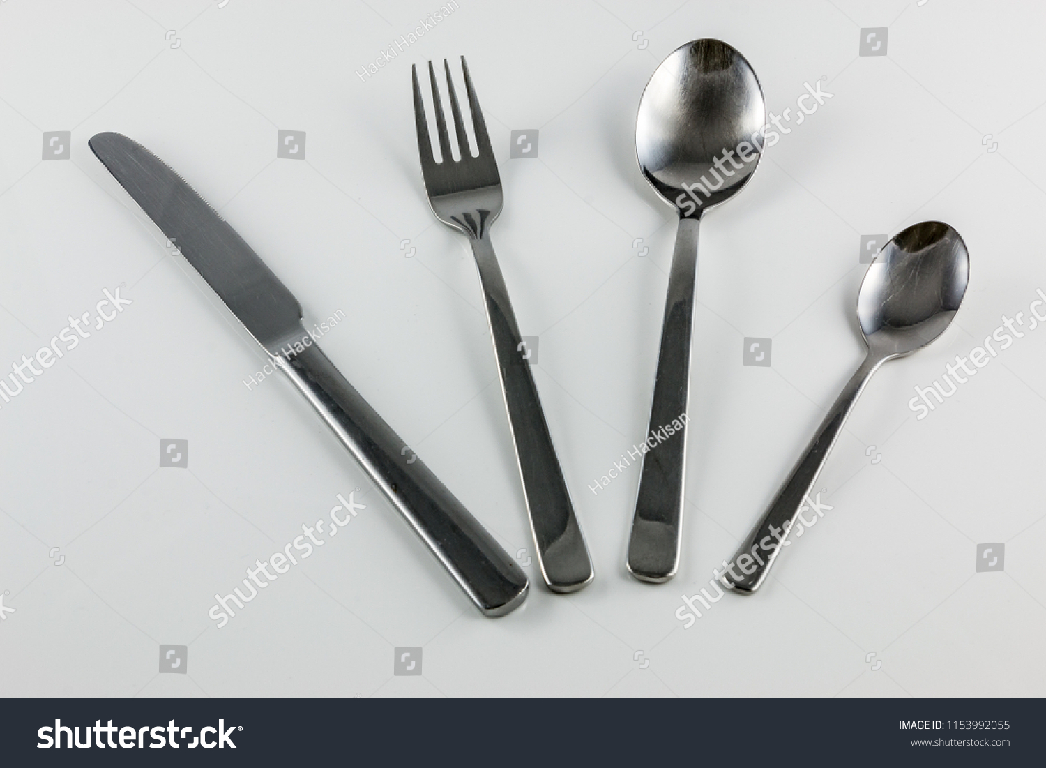Cutlery with knife, fork, table spoon and little spoon #1153992055